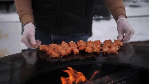 Turkish kebab is cooked on a circular grill in the open air. Stock-Footage 229556625