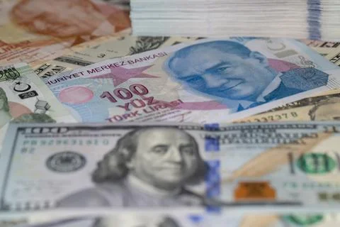 Turkish lira and stack of US dollar banknotes in global currency investment.. Stock Photos