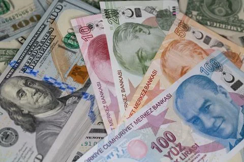 Turkish lira and stack of US dollar banknotes in global currency investment.. Stock Photos