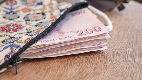 Turkish lira banknotes pile inside traditional ethnic patterned purse on wo.. 스톡 동영상 332107011