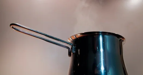 Turkish, mocha coffee pot with boiling water and steam Stock Footage 123549645