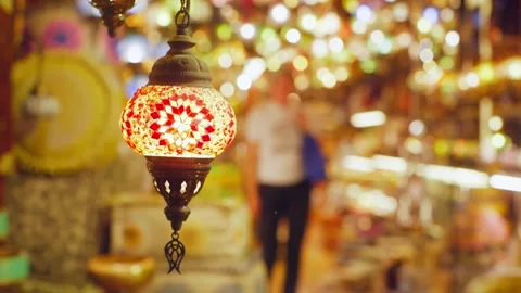 Turkish mosaic lamp hanging in bazaar with glowing bokeh lights 스톡 동영상 337481255