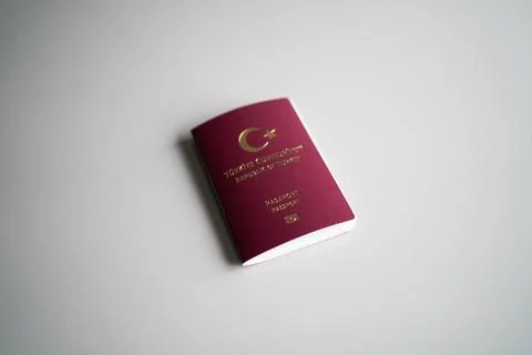 Turkish passport lying on a plain grey surface, high angle view Stock Photos