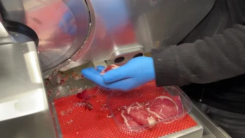 Turkish pastrami cut into thin slices. Chopping Turkish bacon on an electric  Stock Footage 238089430