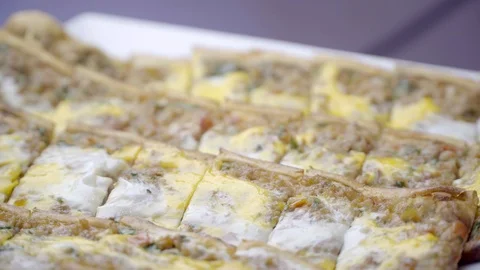 Turkish pide with ground meat in small pieces and egg. rotating shot. Stock Footage 99521957