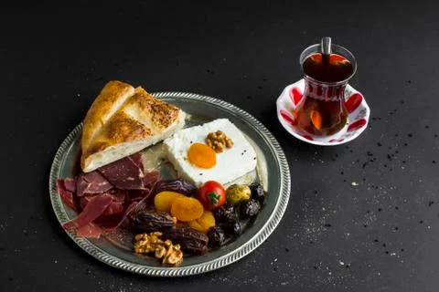 Turkish Ramadan Start Menu with rustic metal tray and Turkish Tea Stock Photos