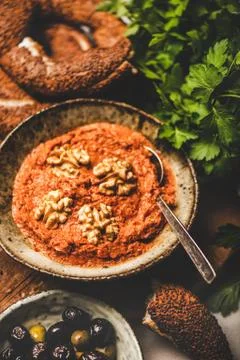 Turkish red pepper paste with walnuts, simit bagels, fresh parsley Stock Photos