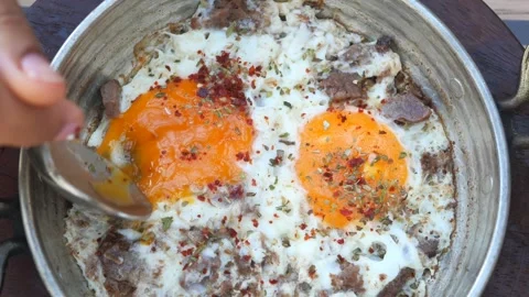 Turkish scrambled eggs with roasted meat in copper pan Video stock 264136922