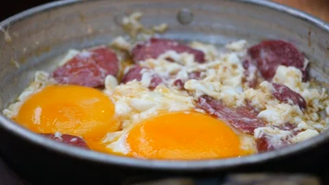 Turkish scrambled eggs with roasted meat in copper pan Video stock 270342086