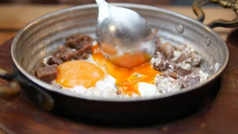 Turkish scrambled eggs with roasted meat in copper pan Video stock 276640503