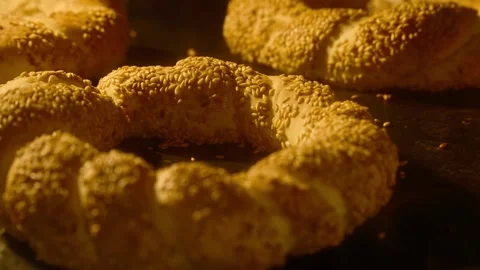 Turkish simit rising up in oven. Baking concept. Traditional Turkish fast food Stock Footage 290086527