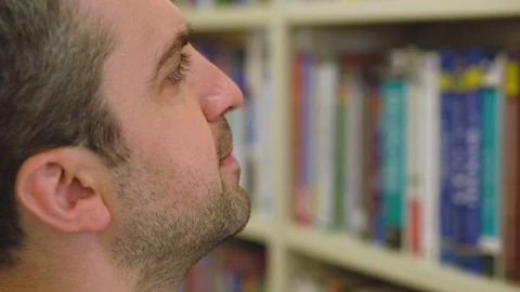 Turkish student chooses book on a shelf in the library close-up Stock Footage 112352906