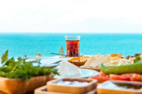 Turkish tea with breakfast on the table in front of sea at summer season Stock Photos