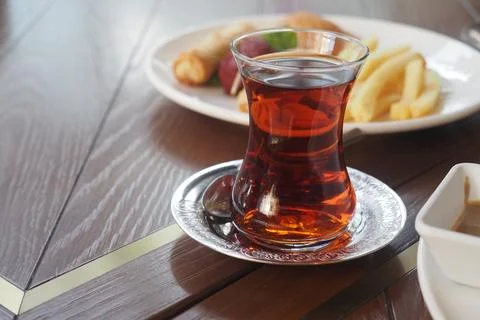 Turkish tea served with snacks at a dining table Stock Photos