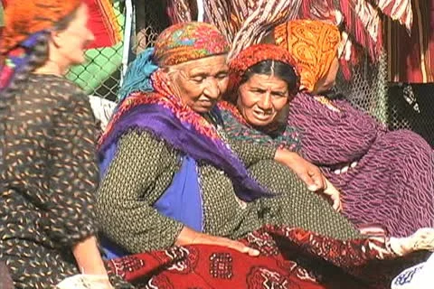 Turkmenistan Tolkuchka market old lady and rug Stock Footage