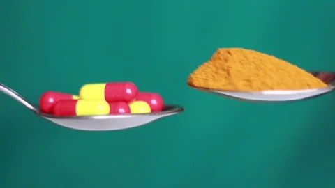 Turmeric and pills comparing Stock Footage 80799633