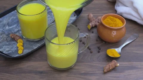 Turmeric milk in a mug. Stock Footage 240166092