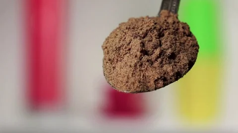 Turmeric powder falling from the silver spoon. Blurred background. Slow motion Stock Footage 75522272