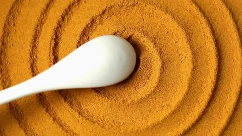 Turmeric powder spirally twisted, close-up image Stock Footage 134207691