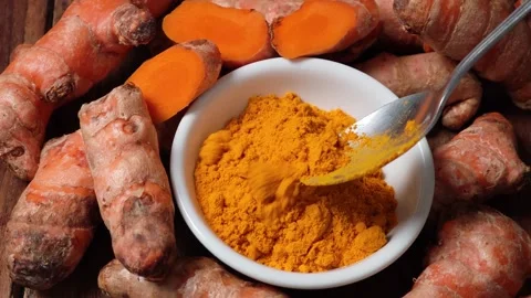 Turmeric powder in a white cup Stock Footage 334863224