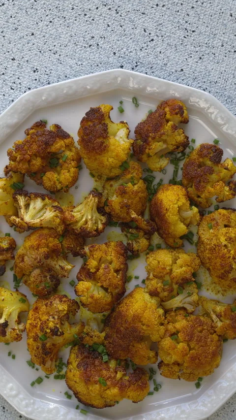 Turmeric Roasted Cauliflower on a serving plate. Vertical video. Stock Footage 308784319