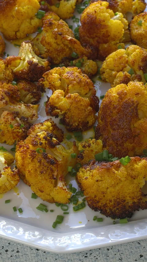 Turmeric Roasted Cauliflower on a serving plate. Vertical video. Stock Footage 309046994
