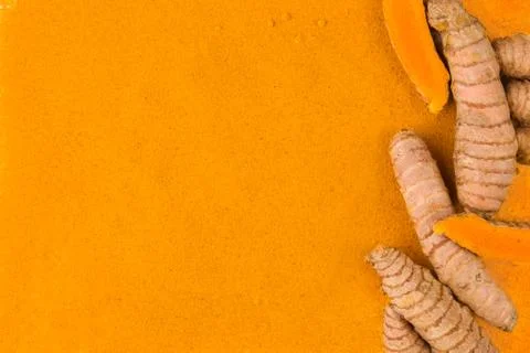 Turmeric root powder background. Stock Photos