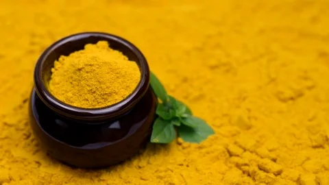 Turmeric in a small brown pot Stock Footage 80372121