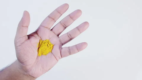 Turmeric Yellow In a Hand Stock Footage 248768667