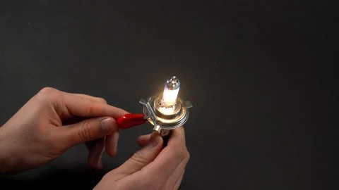 Turn on and turn off halogen bulb for car in hand. Connect lamp contacts Stock Footage 161275132