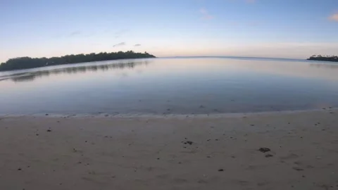 Turn around on beach side with low tide sunset time with beautiful ocean water r Stock Footage 252179136