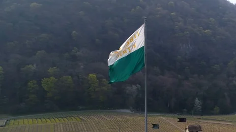 Turn around Vaud flag on Aigle castle - Aerial Phantom 4 drone Stock Footage 106298933
