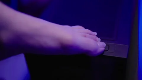 Turn on computer with feet big toe close... | Stock Video | Pond5