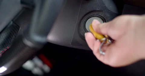 Turn off the engine and remove the key.Yellow car key. Stock Footage 306396229