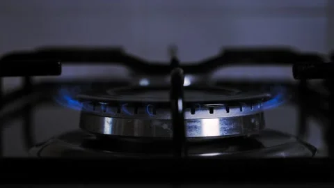 Turn on flame of kitchen stove. use gas to cook, cook on low heat. climate  Stock Footage 212045575