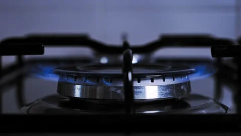 Turn on flame of kitchen stove. use gas to cook, cook on low heat. climate  Stock Footage 212045601