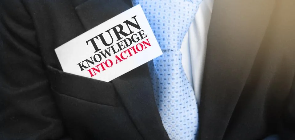 Turn Knowledge Into Action card in upper pocket of businessman. Motivation fo 库存照片