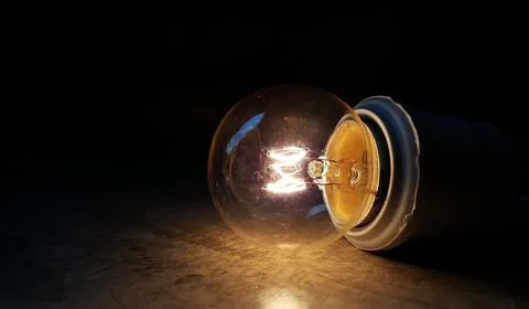 Turn on the lamp in the dark. Stock Photos