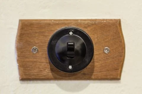Turn on the light with old-fashioned switch on the wall Stock Photos