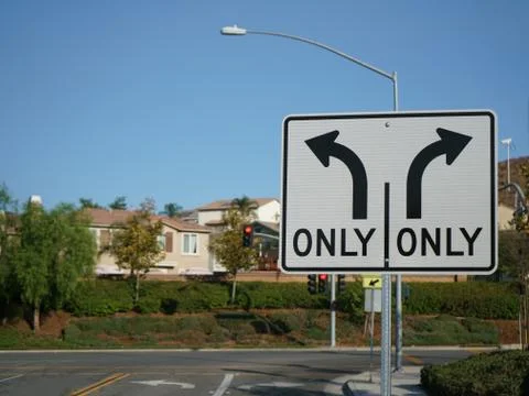 Turn Only Road Sign with intersection in background Stock Photos