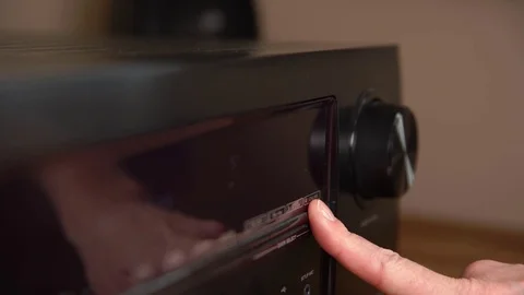 To turn on the radio function and turn up the volume on the black receiver Stock Footage 121769852