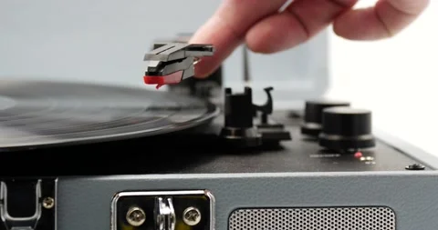 Turn on record player close up on man's hand music playing Stock Footage 150250972