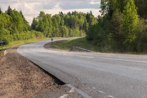 Turn of the road in the forest Foto stock