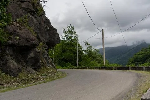 Turn of the road in the mountains, cloudy sky, Georgia Stock Photos