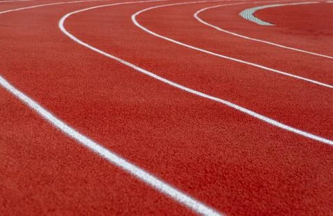 Turn  of the rubber treadmill  in empty stadium in blur. Stock Photos