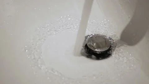 Turn on running water flows from the tap to the white sink and turn off Stock Footage 171575856