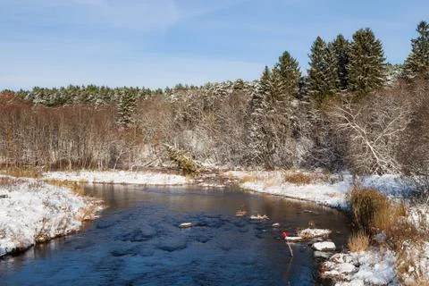 Turn of small river close to snow forest Stock Photos