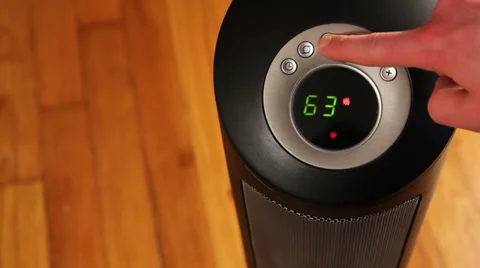 Turn on space heater, oscillate, close up Stock Footage