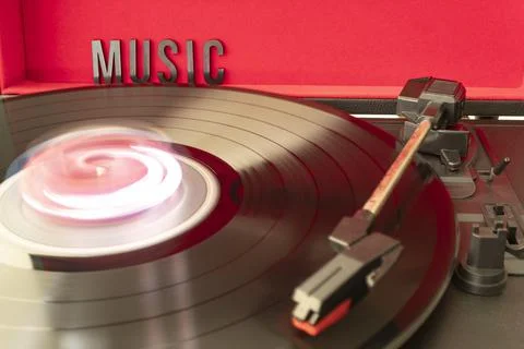 Turn table needle playing a LP vinyl disc with turn table and MUSIC lettering Stock Photos