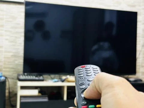 Turn on tv remote control Stock Photos